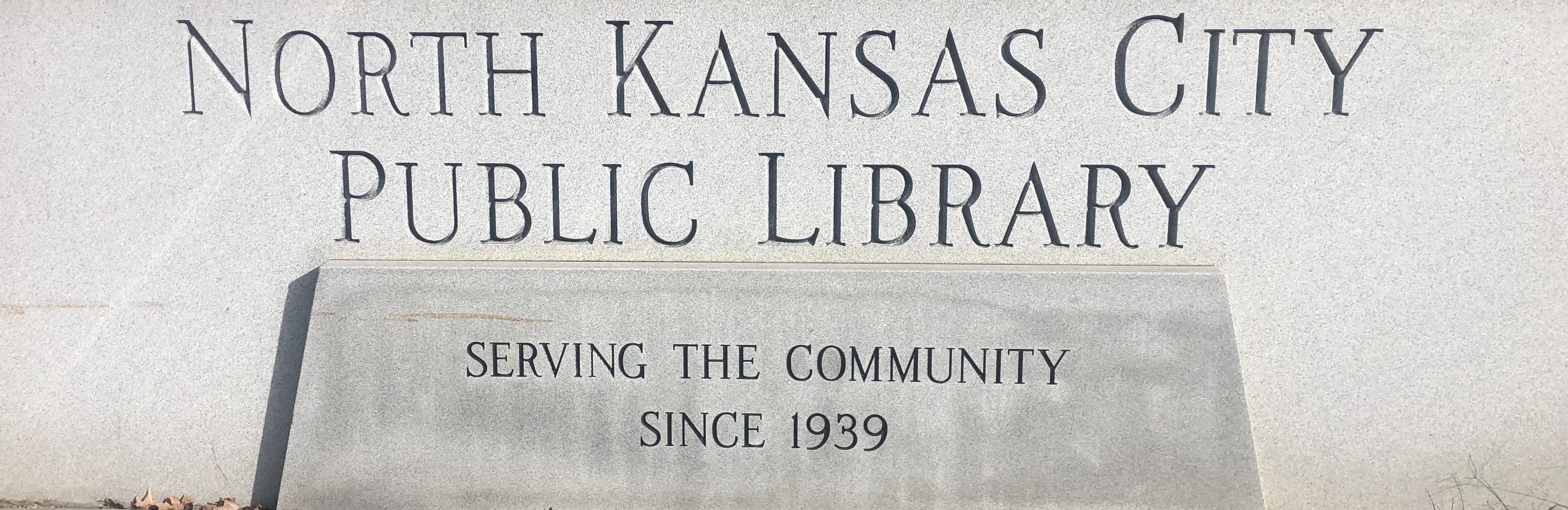 image of a sign reading north kansas city public library, serving the community since 1939