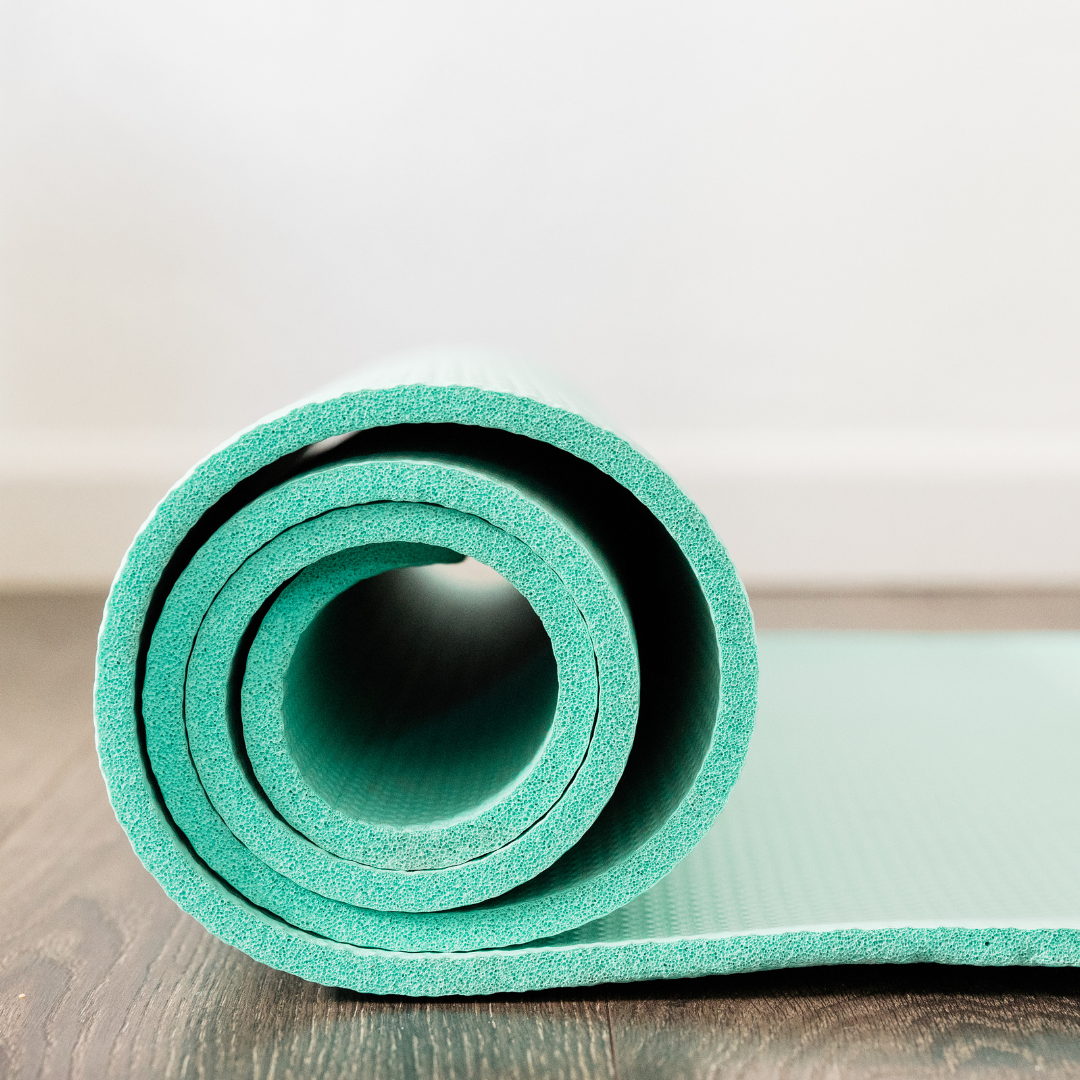 Teal yoga mat on floor